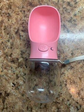 Pb+ QQPets Pink Portable Dog Water Bottle with a built-in dispenser.